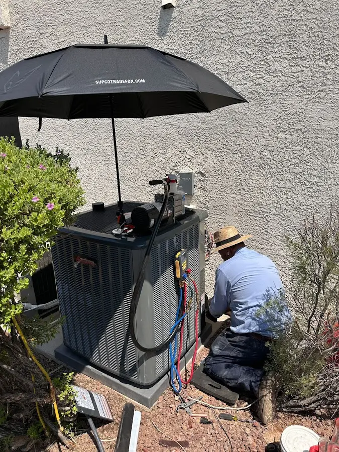 HVAC technician performing outdoor AC maintenance in Sellersburg